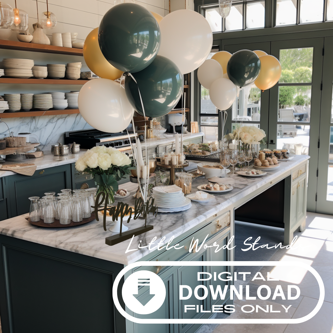Beautiful green kitchen with marble counters. On the island there is a birthday feast set up with treats and champagne. Among the balloons and party food is the Happy Birthday Little Word Stand