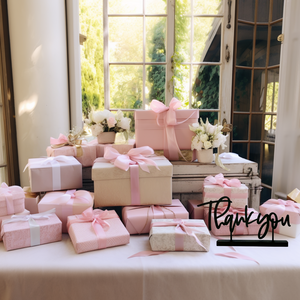 Table with blush table cloth and a stack of wedding gifts all wrapped in shades and textures of pink wrapping paper. The Thank You Little Word Stand sits on the table. A graphic over top reads - digital download files only-