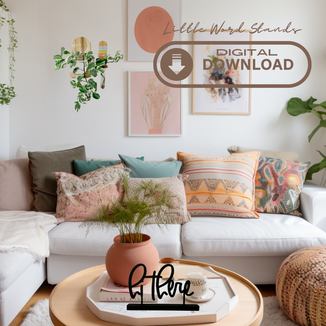 A colorful and cozy little boho living room. Colorful throw pillows and pretty art on the walls, plants and a comfy white sectional sofa. On the coffee table is a try holding books, a plant and the hi there Little Word Stand