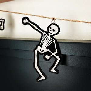 skeleton in modified dab position hang from a jute string