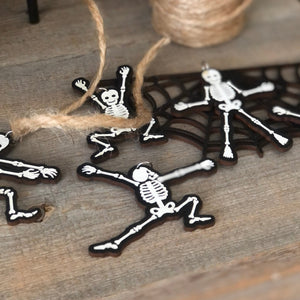 pieces of the skeleton garland sitting on a rustic bench